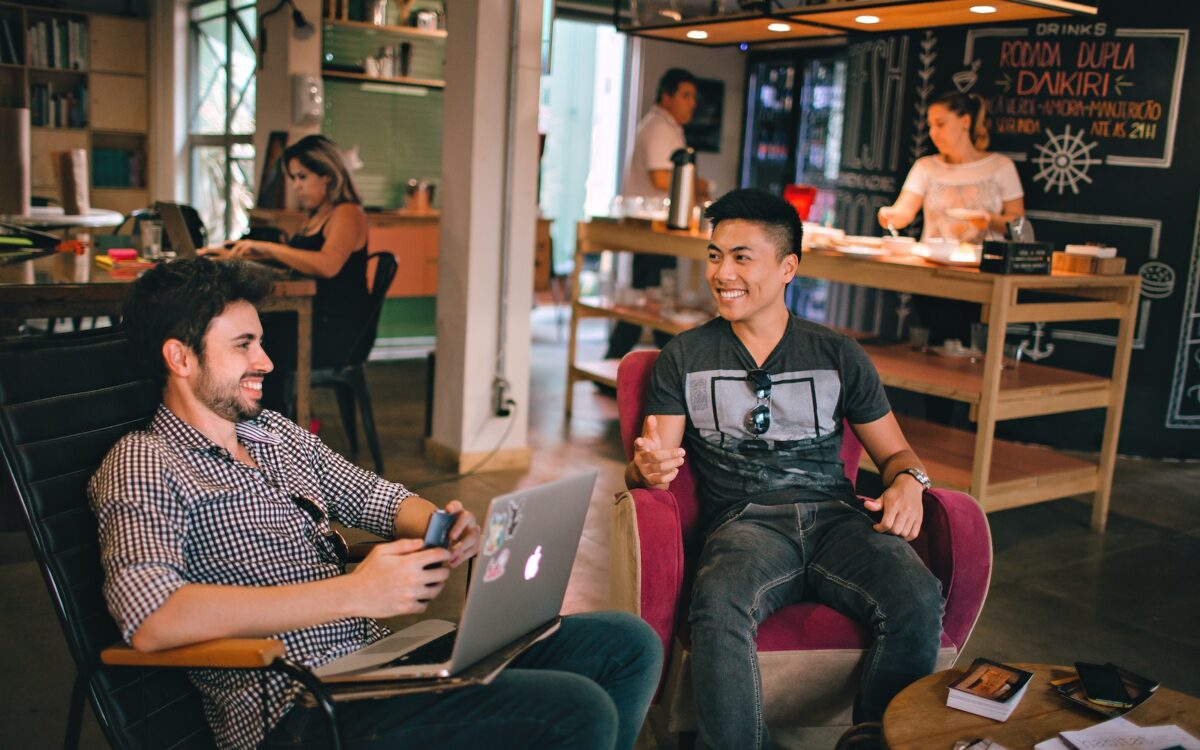 Photograph of Men Having Conversation Seating on Chair