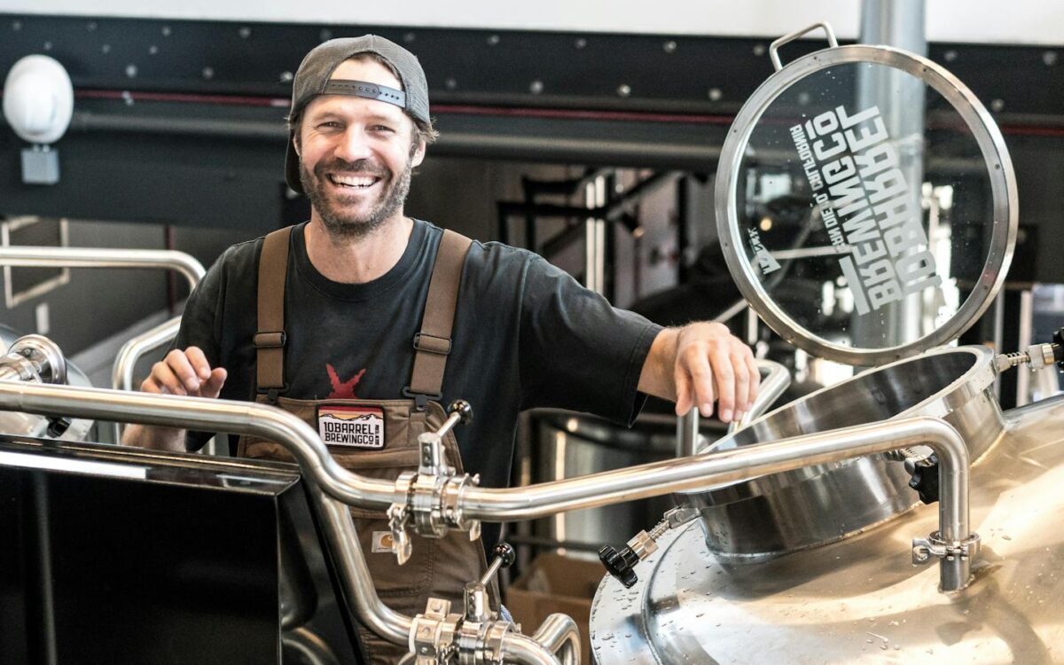 Happily Smiling Man Standing Near Gray Bars