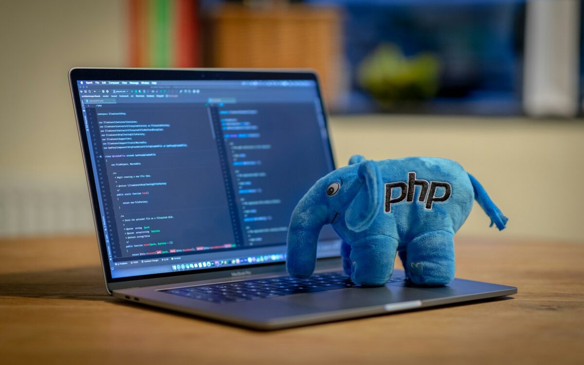 blue and white elephant plush toy on black laptop computer